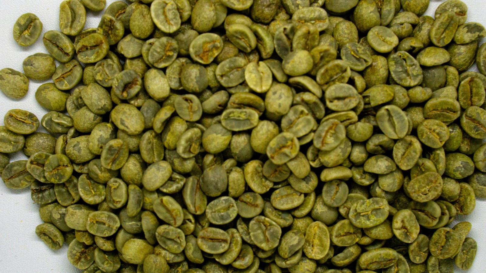 A pile of green, unroasted coffee beans