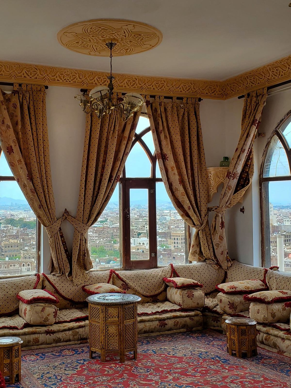 A traditional Yemeni room in Sana'a with arched windows over the city